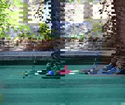 A person playing mini golf.