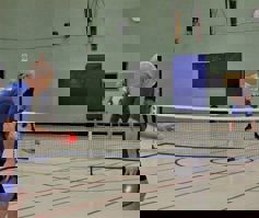 Two men playing pickleball.