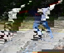 A skateboarder skating in a park.